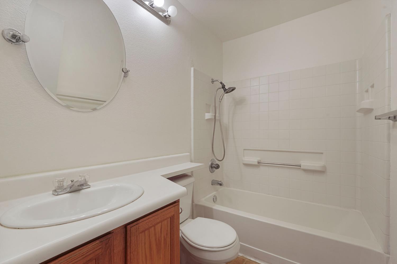 2449 Calvert Street Stockton, CA 95210 - Photo 19 of 37 a bathroom with a sink a toilet and a mirror