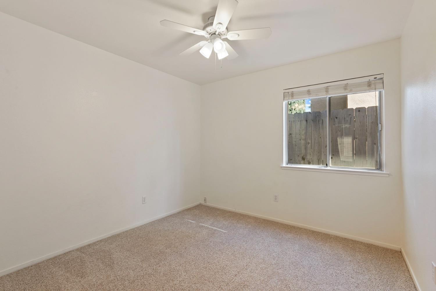 2449 Calvert Street Stockton, CA 95210 - Photo 20 of 37 an empty room with a window and a fan