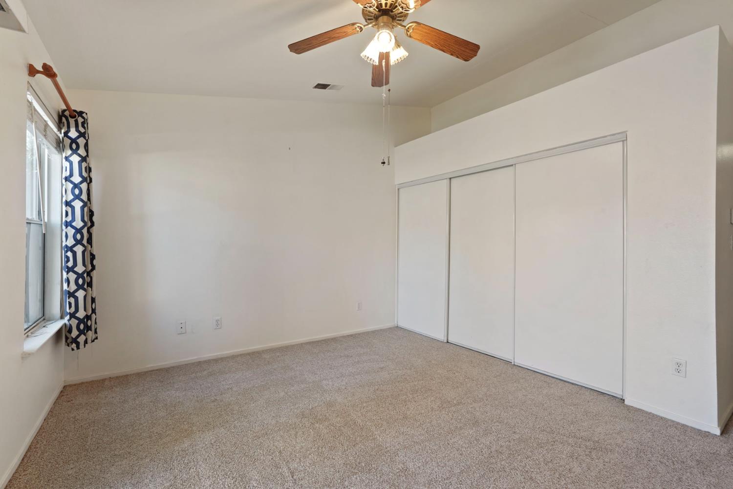 2449 Calvert Street Stockton, CA 95210 - Photo 27 of 37 an empty room with chandelier fan