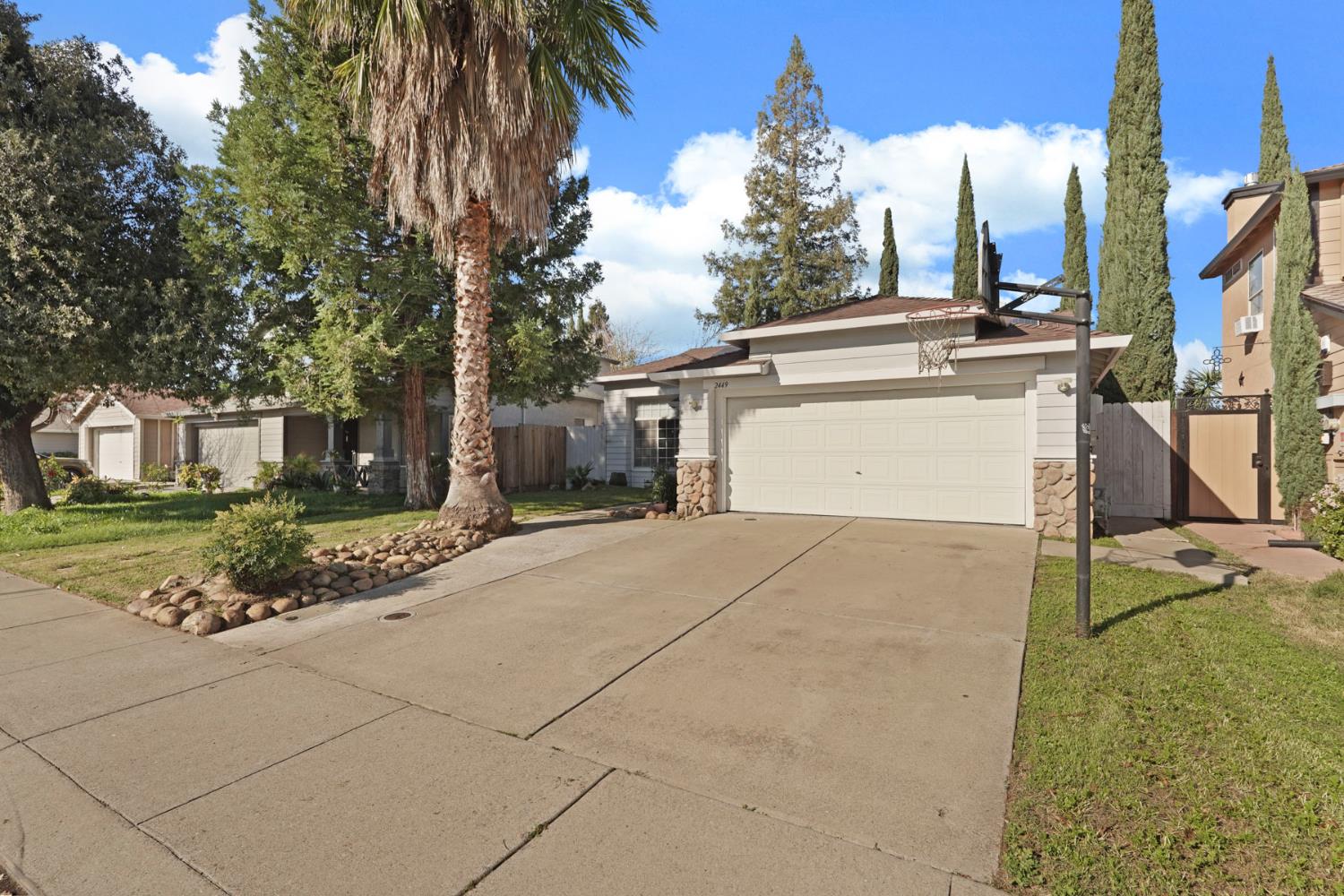 2449 Calvert Street Stockton, CA 95210 - Photo 4 of 37 a front view of a house with a yard and garage