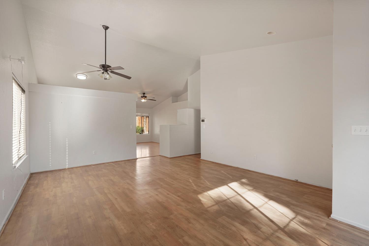 2449 Calvert Street Stockton, CA 95210 - Photo 9 of 37 a view of an empty room with window and wooden floor