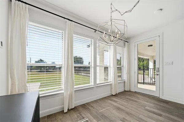 a view of a livingroom with wooden floor and a ceiling fan