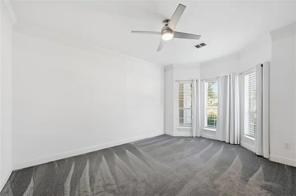 a view of a room with wooden floor and windows