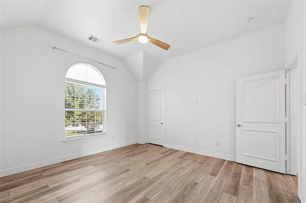 a view of a room with wooden floor