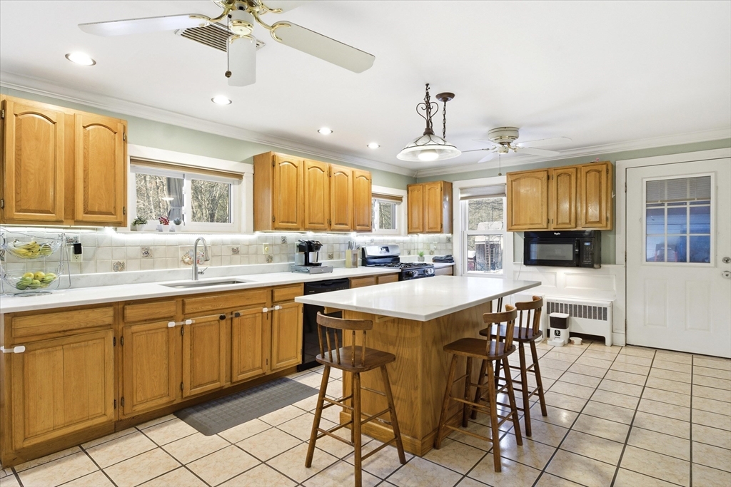 16 Worcester Road Townsend, MA 01469 - Photo 7 of 42 a kitchen with cabinets a sink dining table and chairs