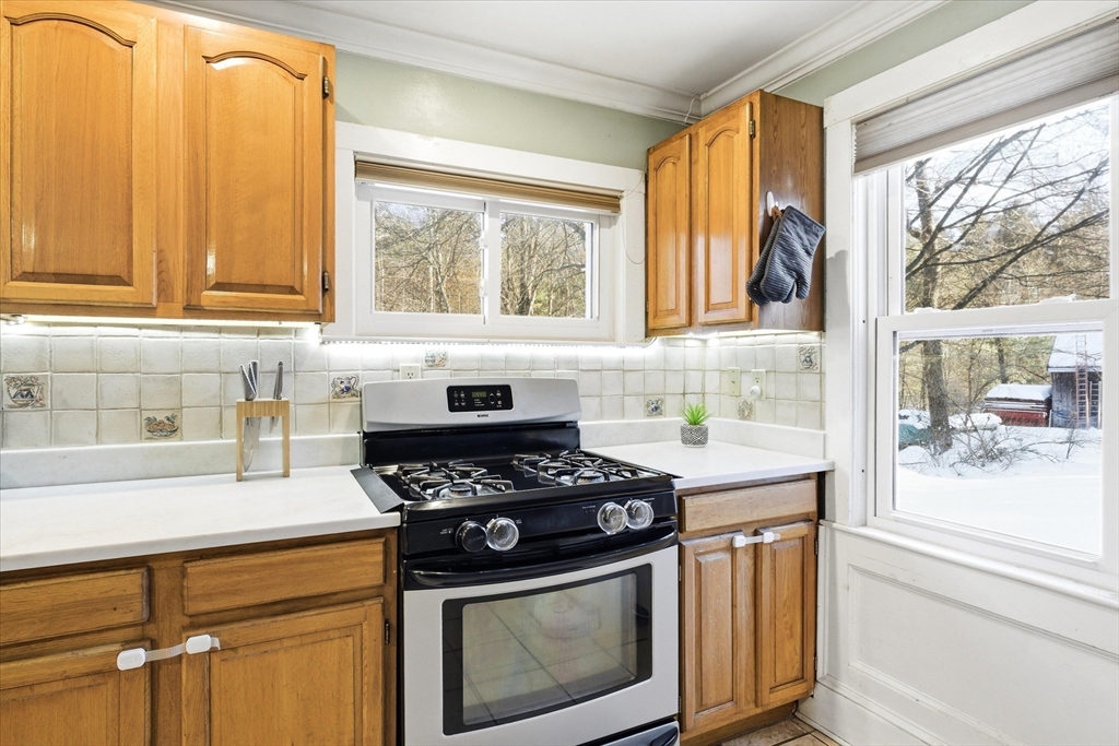 16 Worcester Road Townsend, MA 01469 - Photo 9 of 42 a kitchen with a stove a sink and wooden cabinets