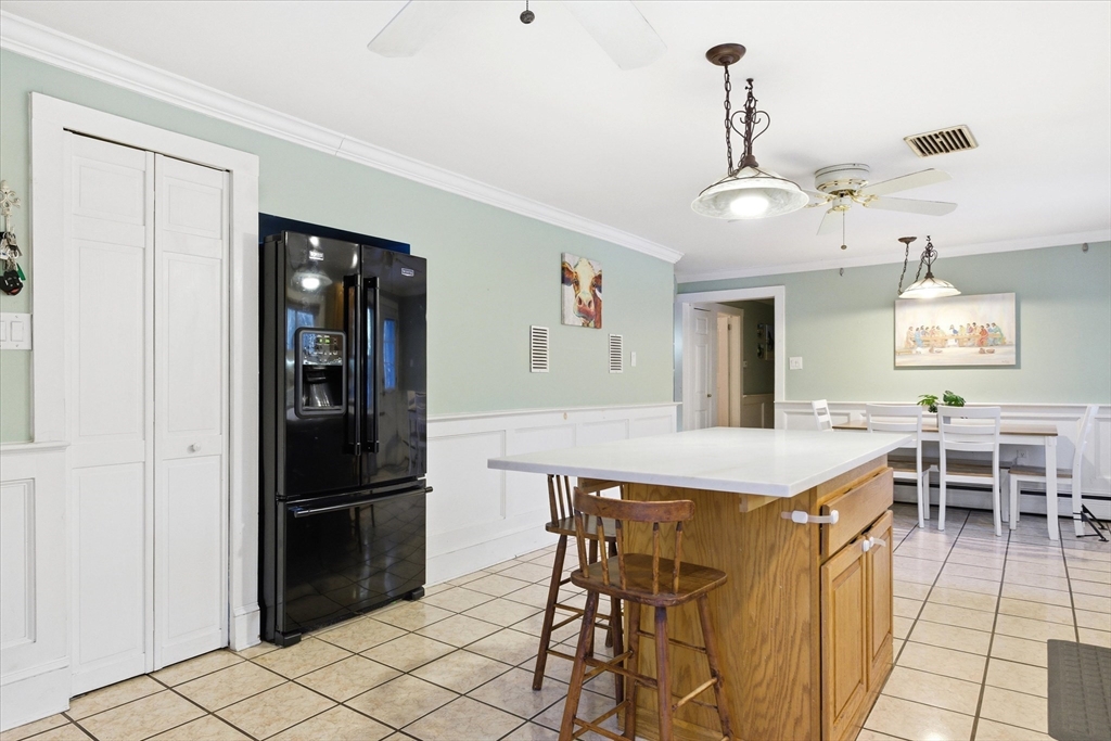 16 Worcester Road Townsend, MA 01469 - Photo 10 of 42 a kitchen with stainless steel appliances kitchen island granite countertop dining table chairs and chandelier