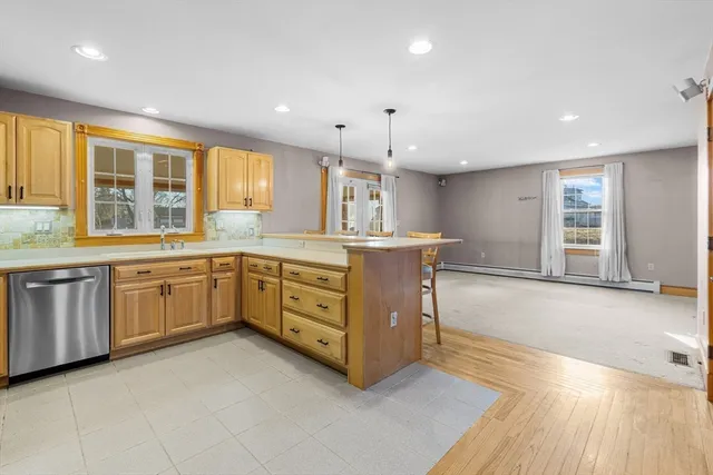 a kitchen with a sink window and cabinets