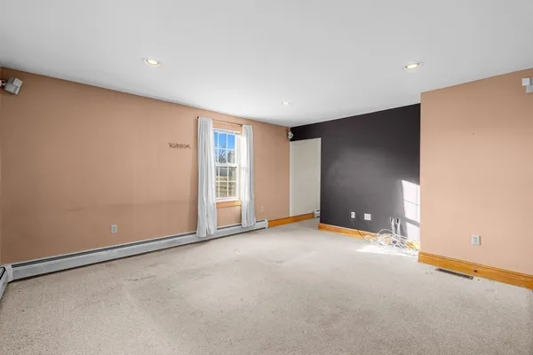 an empty room with closet and windows