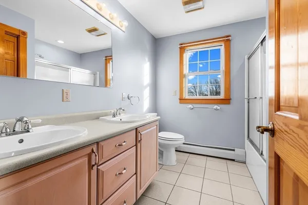 a bathroom with a sink a vanity and a toilet