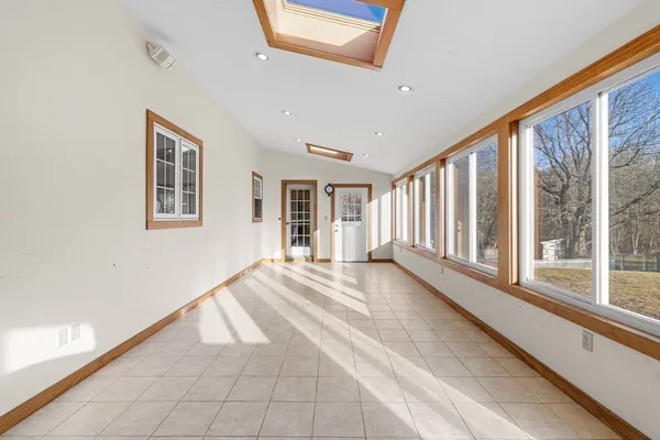 a view of an entryway with wooden floor and windows