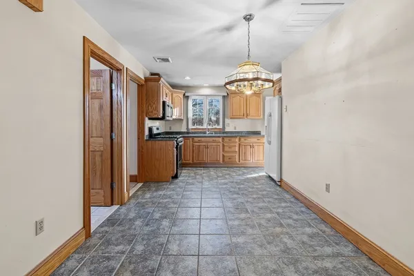 a kitchen with stainless steel appliances granite countertop a refrigerator and a stove top oven
