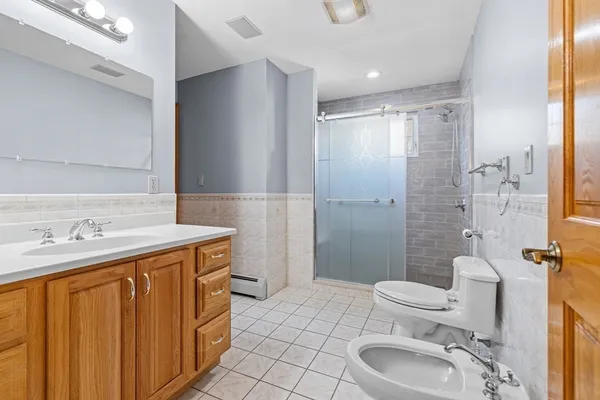 a bathroom with a sink toilet and shower