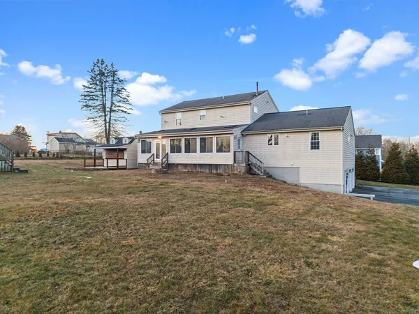 a view of a house with a backyard
