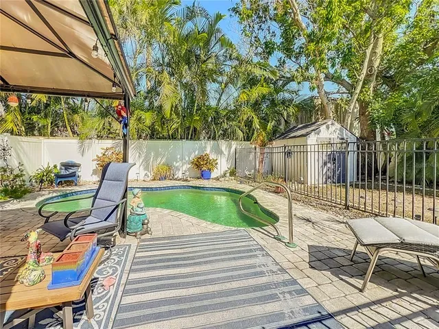 a view of a chair and tables in the patio