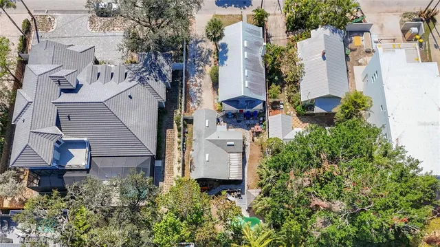 an aerial view of a house with a yard and plants