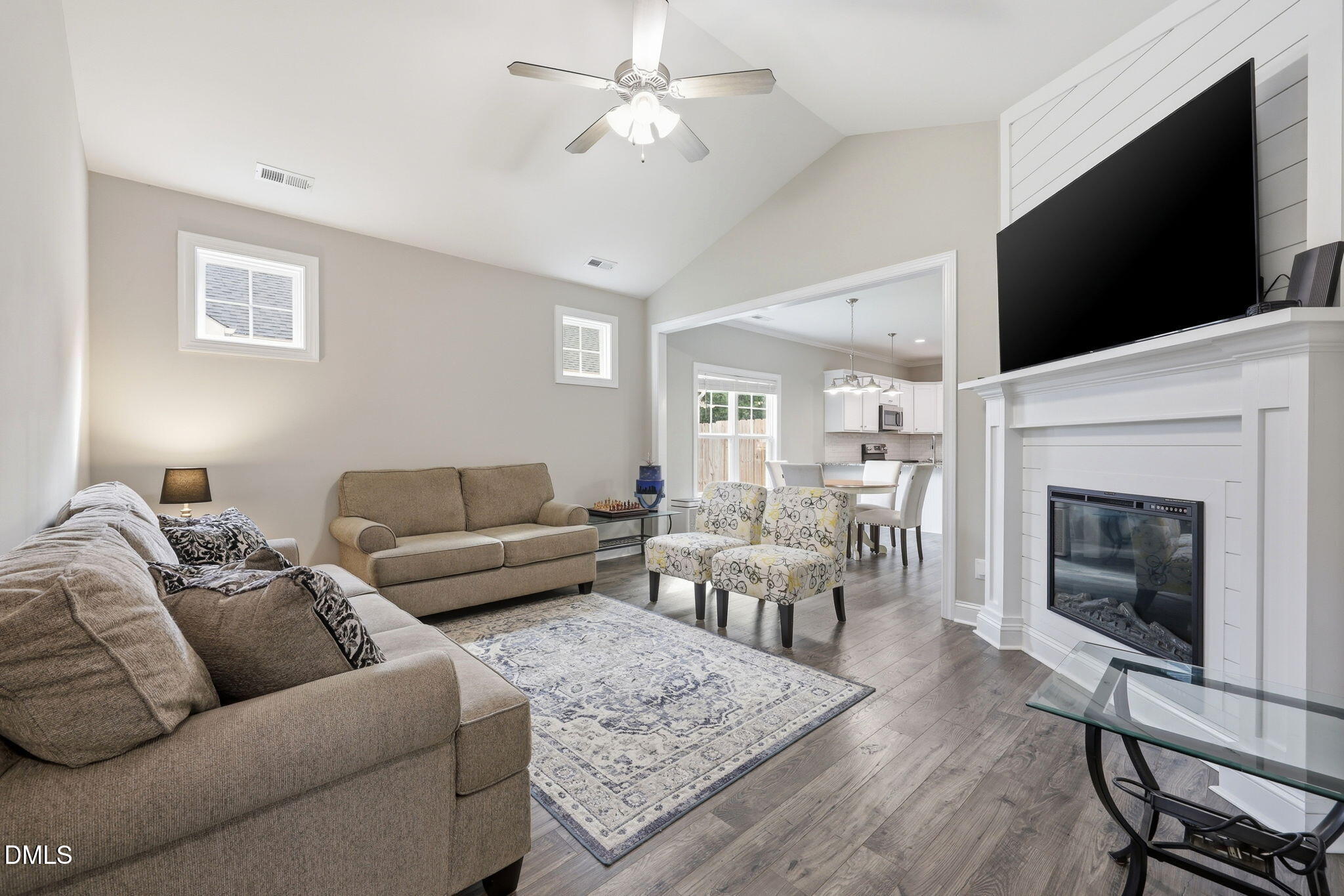 709 South Pollock Street Selma, NC 27576 - Photo 8 of 30 a living room with furniture a flat screen tv and a fireplace