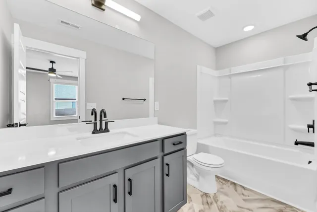 a bathroom with a sink a toilet and a bathtub