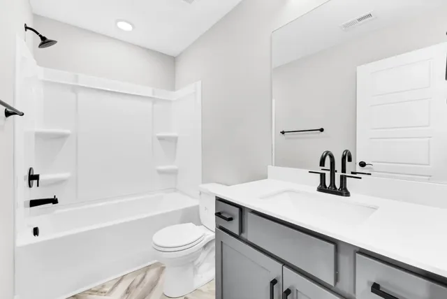 a bathroom with a sink a toilet and a bathtub