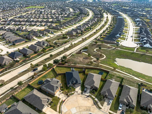 an aerial view of residential houses with outdoor space