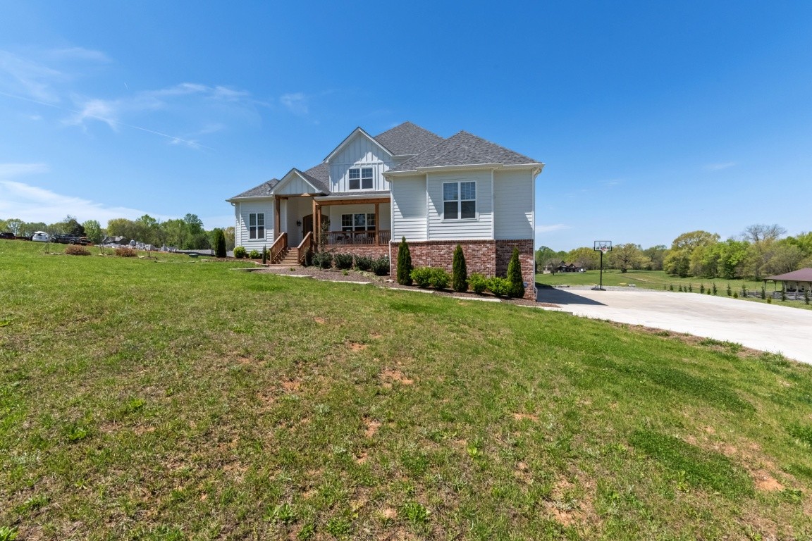 6926 Cairo Bend Road Lebanon, TN 37087 - Photo 2 of 42 a front view of a house with a yard