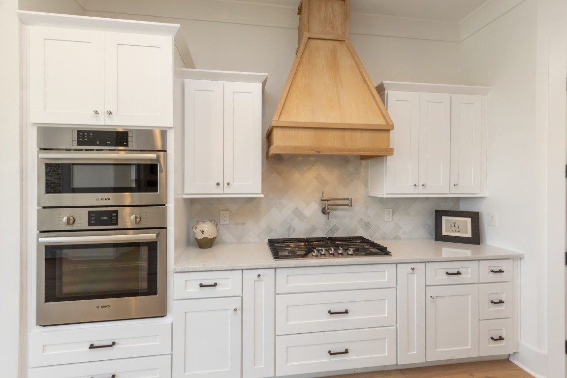 6926 Cairo Bend Road Lebanon, TN 37087 - Photo 12 of 42 a kitchen with stainless steel appliances white cabinets and a stove