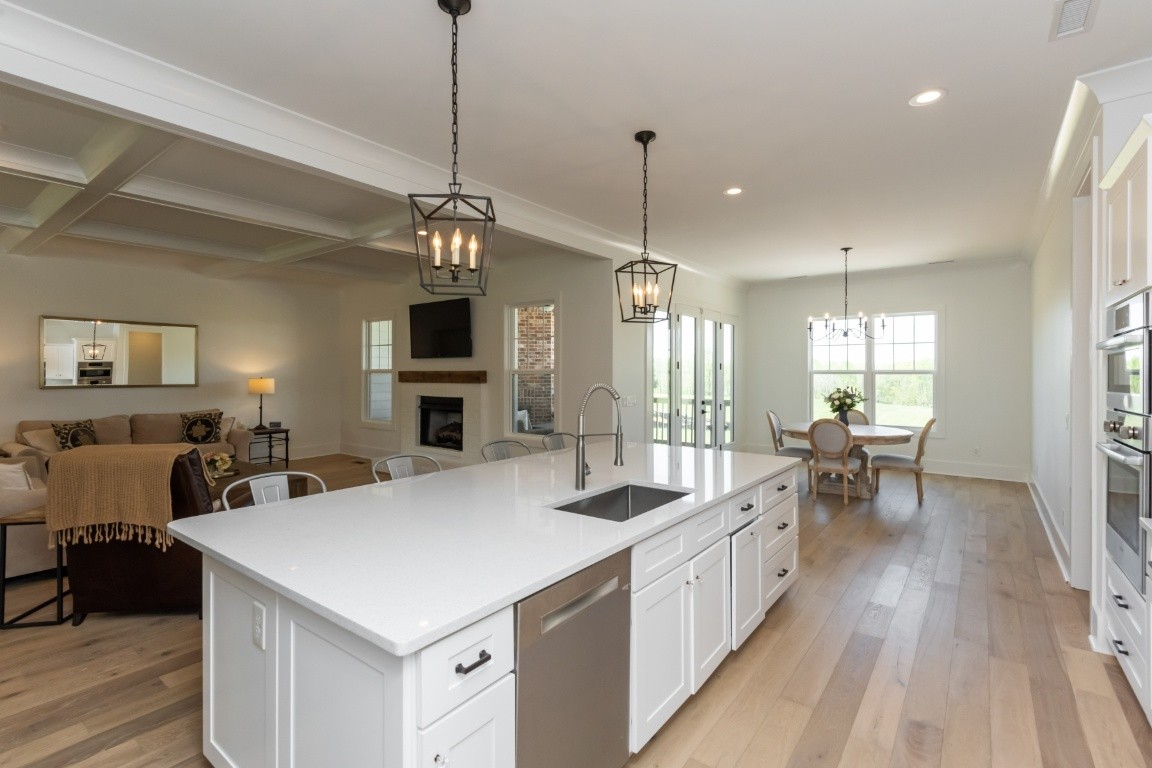 6926 Cairo Bend Road Lebanon, TN 37087 - Photo 13 of 42 a large kitchen with a center island wooden floor and stainless steel appliances