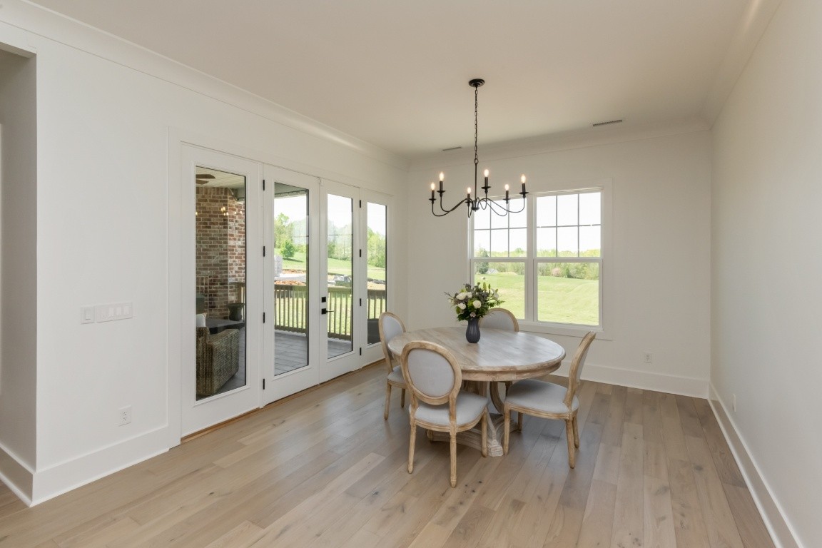 6926 Cairo Bend Road Lebanon, TN 37087 - Photo 14 of 42 a view of a dining room with furniture window and wooden floor