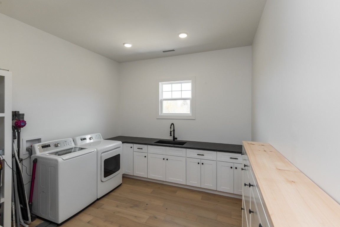 6926 Cairo Bend Road Lebanon, TN 37087 - Photo 17 of 42 a utility room with cabinets washer and dryer