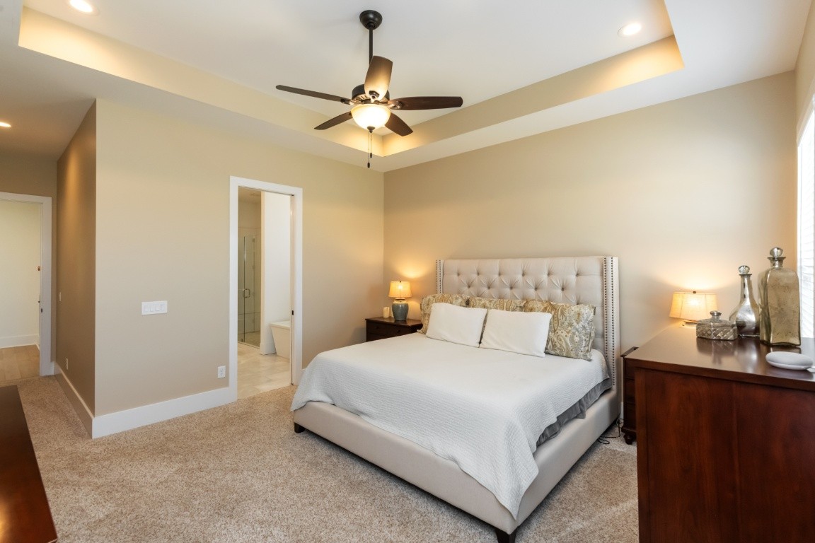 6926 Cairo Bend Road Lebanon, TN 37087 - Photo 19 of 42 a bedroom with a large bed and a chandelier