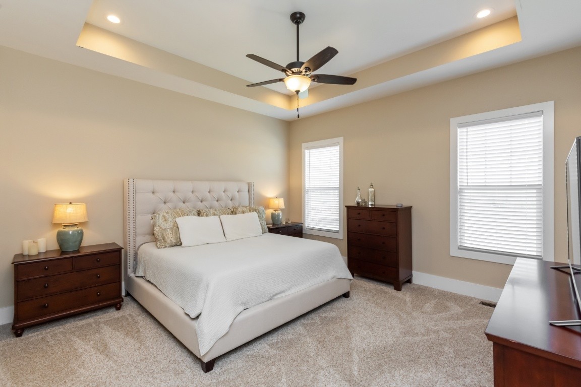 6926 Cairo Bend Road Lebanon, TN 37087 - Photo 20 of 42 a bedroom with a bed and a chandelier