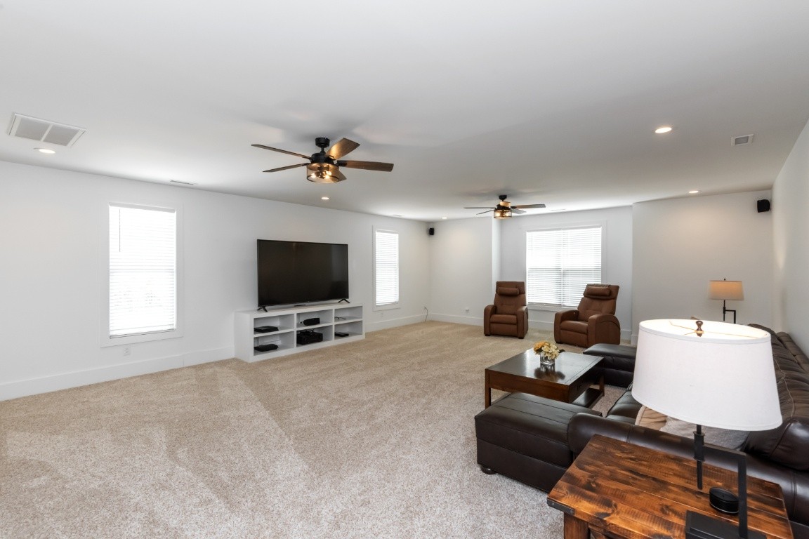 6926 Cairo Bend Road Lebanon, TN 37087 - Photo 25 of 42 a living room with furniture and a flat screen tv