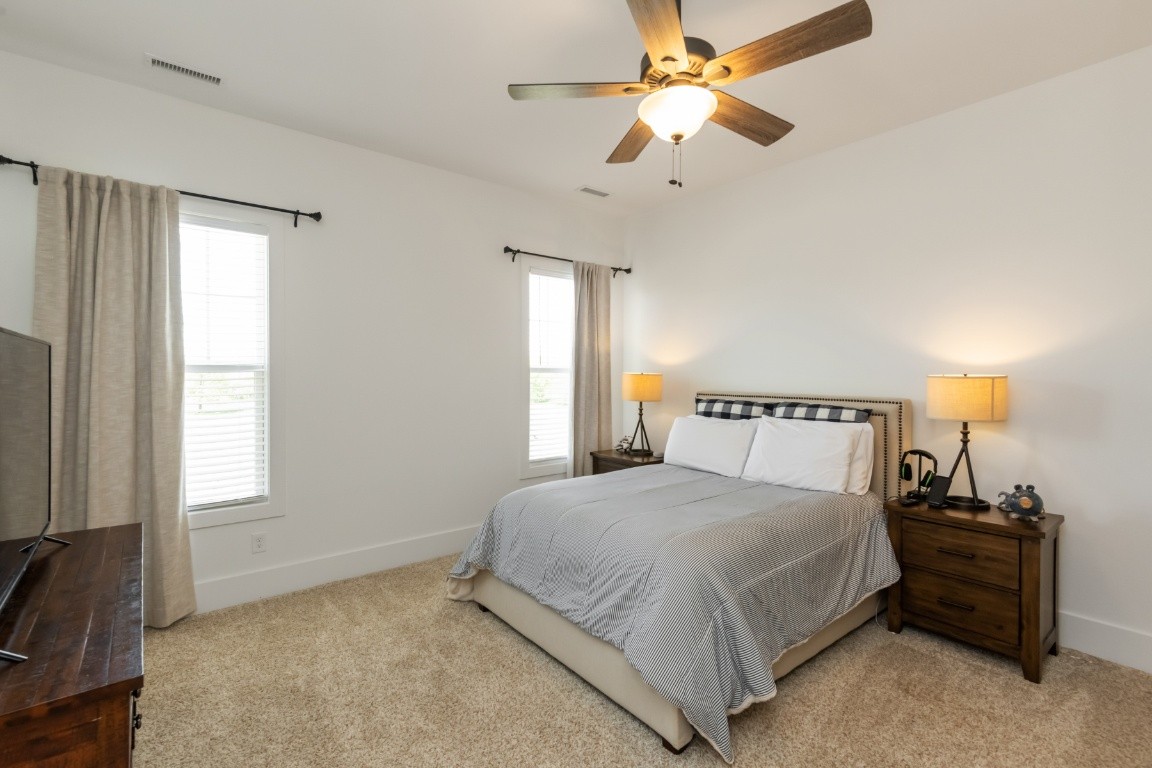 6926 Cairo Bend Road Lebanon, TN 37087 - Photo 27 of 42 a bedroom with a bed and a chandelier