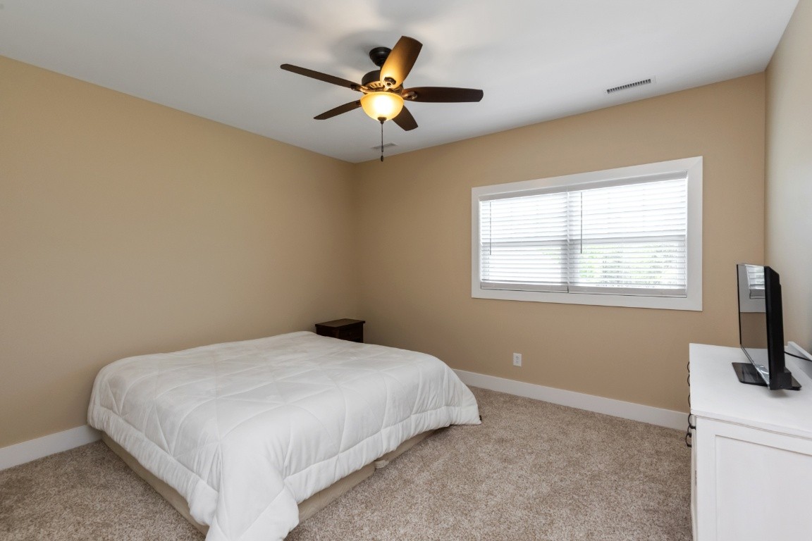 6926 Cairo Bend Road Lebanon, TN 37087 - Photo 31 of 42 a bedroom with a bed and a flat screen tv