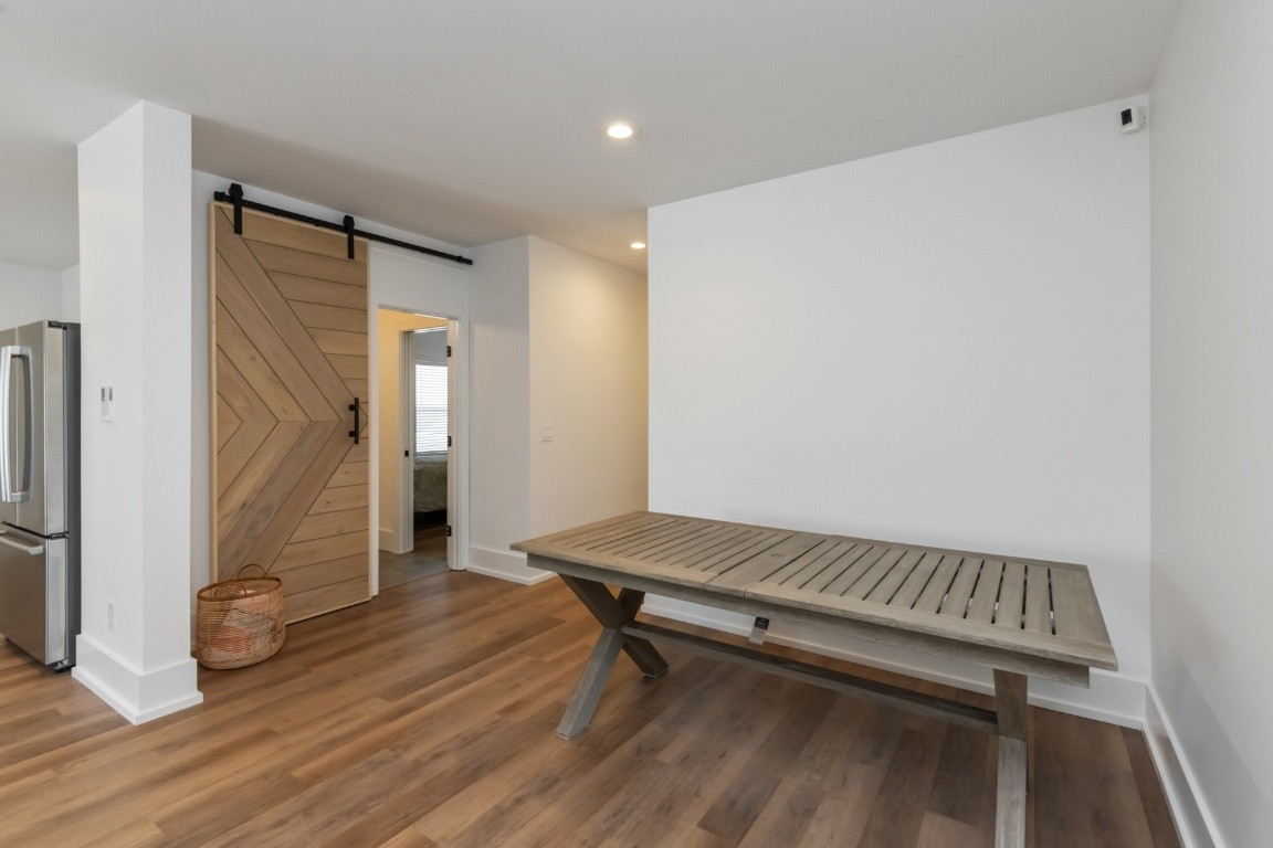 6926 Cairo Bend Road Lebanon, TN 37087 - Photo 40 of 42 a room with a table and wooden floor