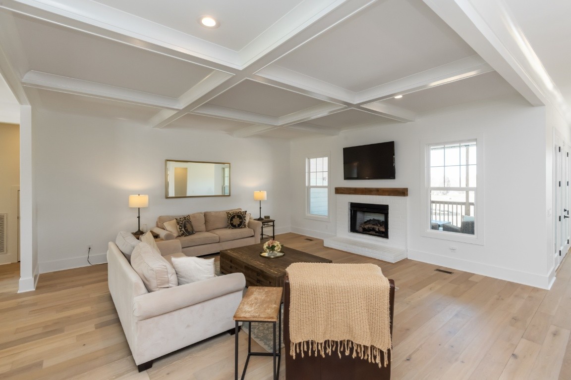 6926 Cairo Bend Road Lebanon, TN 37087 - Photo 6 of 42 a living room with furniture a fireplace and a flat screen tv