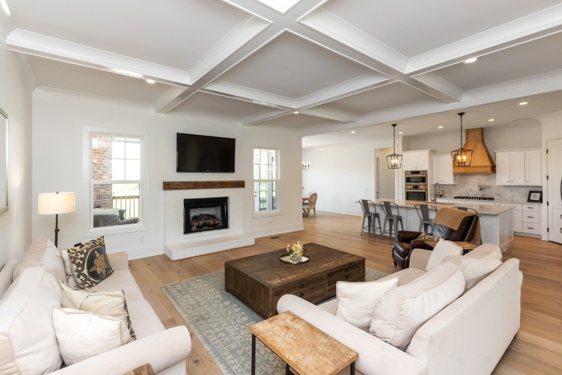 6926 Cairo Bend Road Lebanon, TN 37087 - Photo 8 of 42 a living room with furniture a fireplace and a flat screen tv