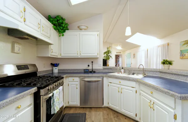 a kitchen with a sink stove and cabinets