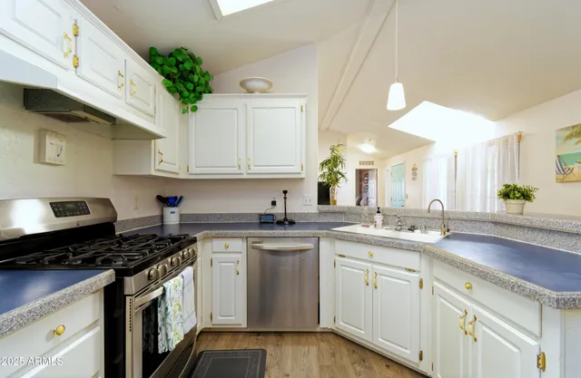 a kitchen with a sink stove and cabinets