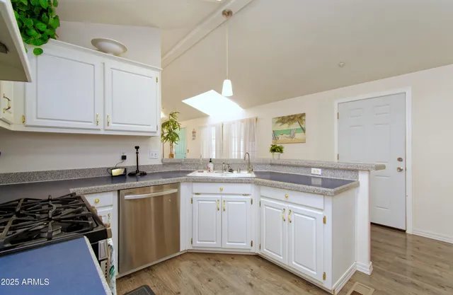 a kitchen with a sink stove and cabinets