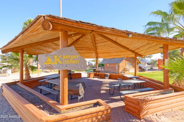 a view of a patio with a table and chairs under an umbrella