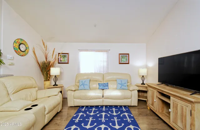 a living room with furniture and a flat screen tv