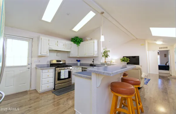 a kitchen with a sink cabinets and wooden floor