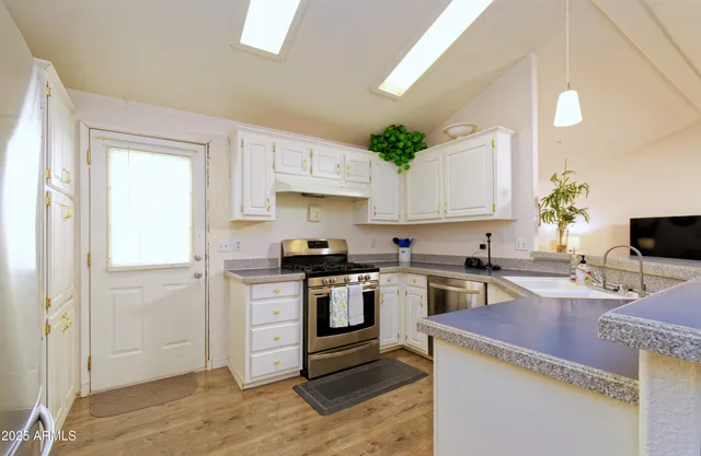 a kitchen with a stove microwave and cabinets