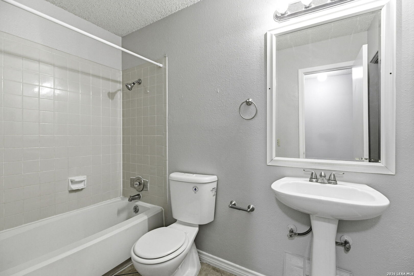 9439 Charter Point San Antonio, TX 78250 - Photo 11 of 14 a bathroom with a sink toilet and shower