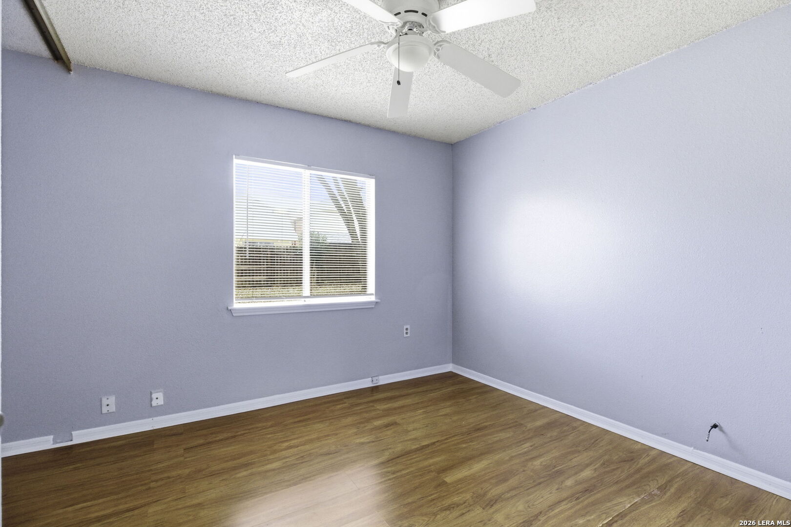 9439 Charter Point San Antonio, TX 78250 - Photo 12 of 14 wooden floor in an empty room with a window