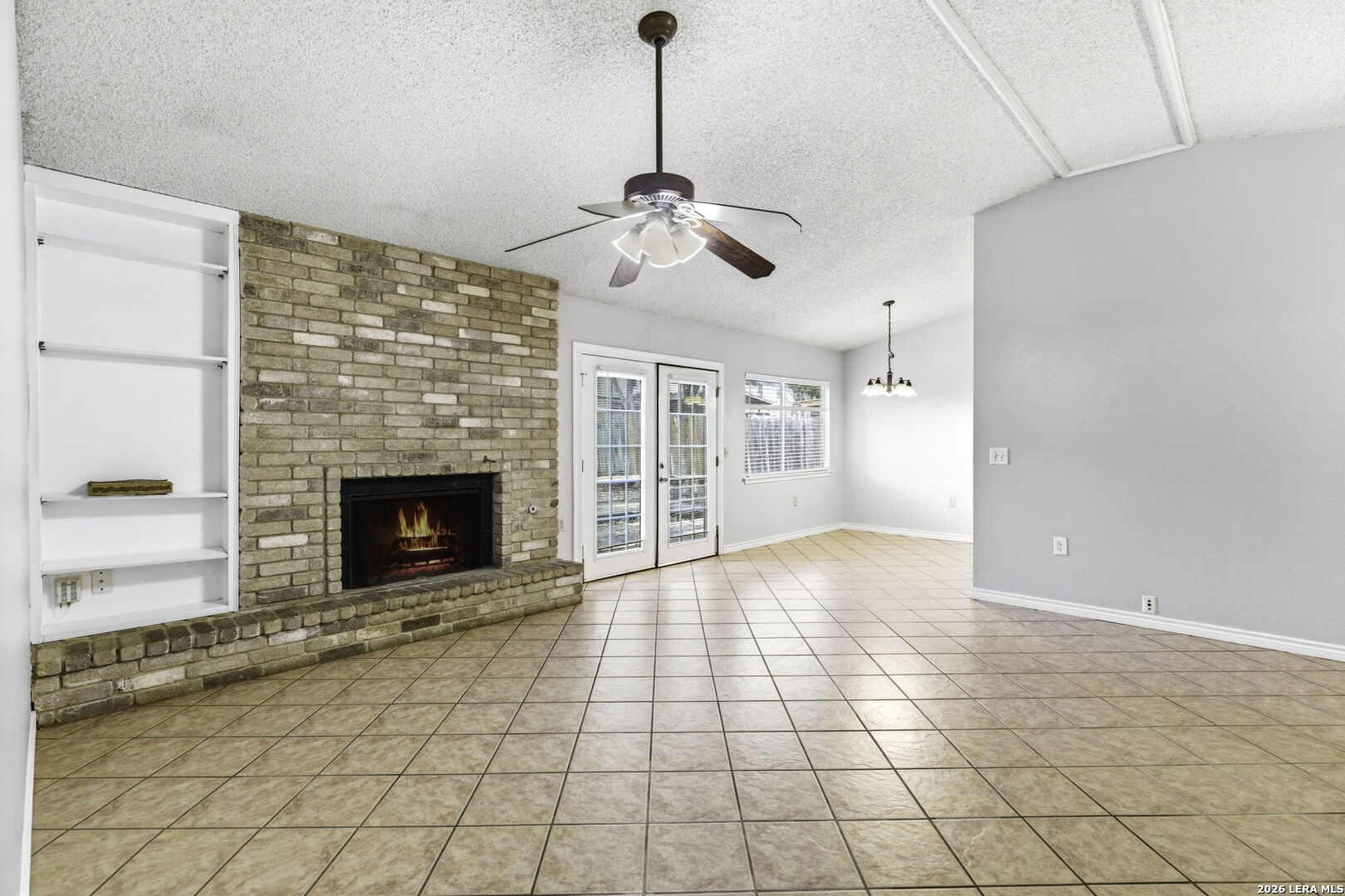 9439 Charter Point San Antonio, TX 78250 - Photo 3 of 14 a view of an empty room with glass door