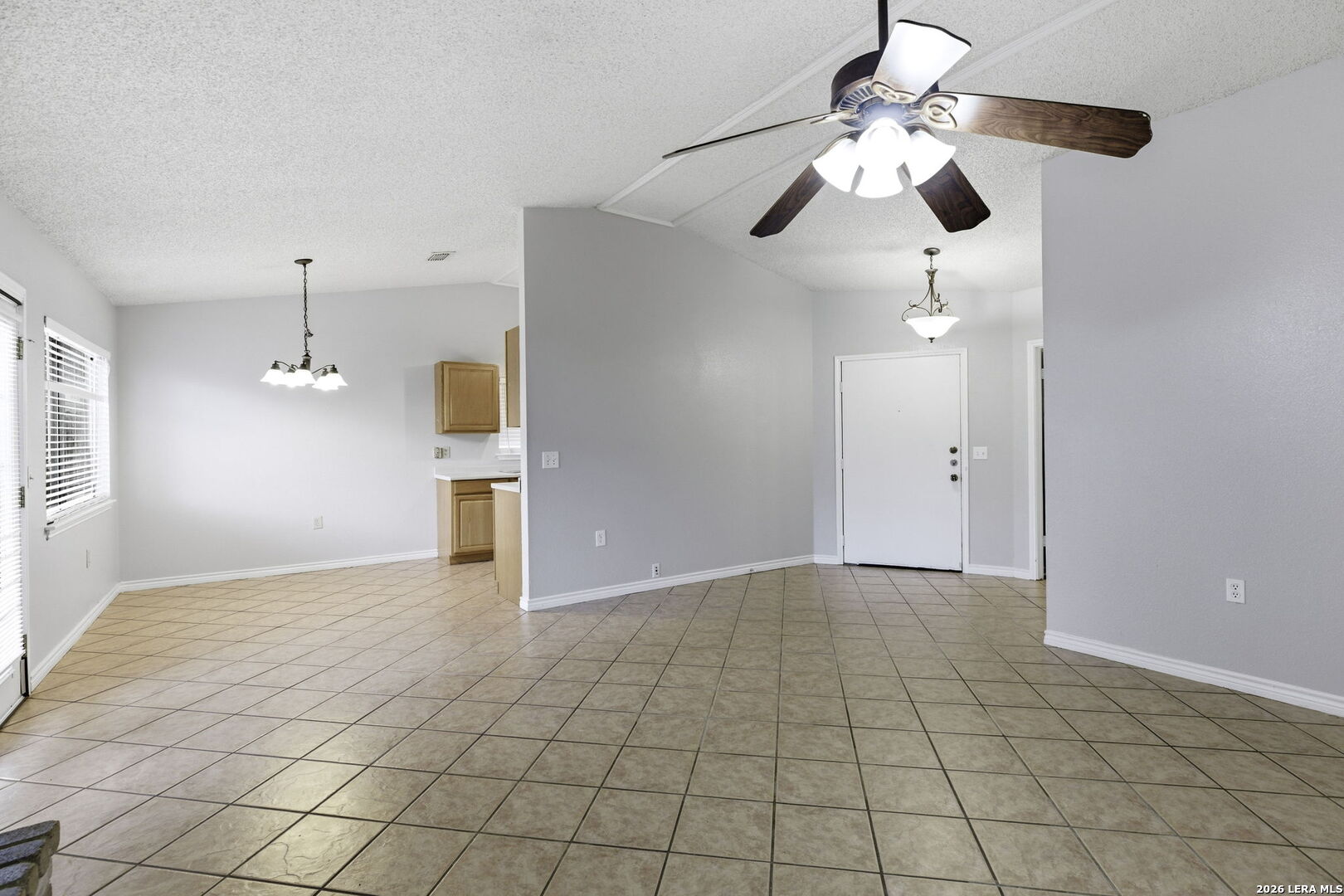 9439 Charter Point San Antonio, TX 78250 - Photo 5 of 14 a view of an empty room and chandelier fan