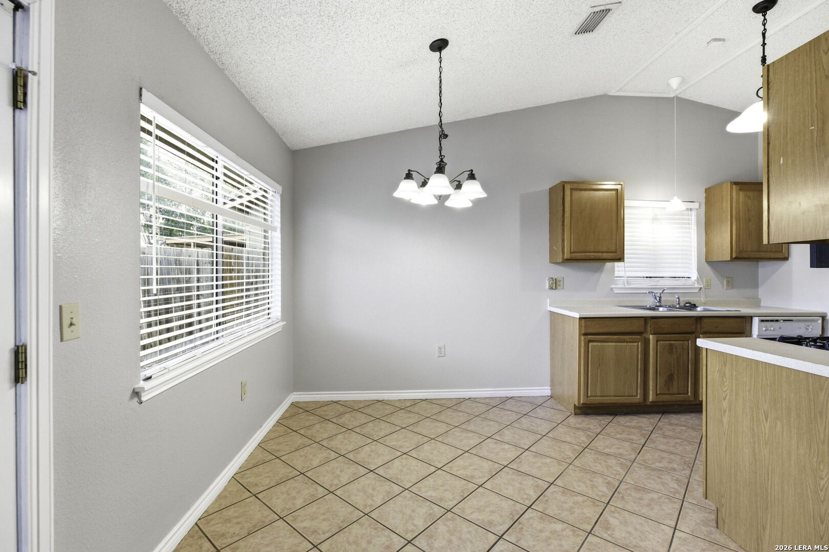 9439 Charter Point San Antonio, TX 78250 - Photo 6 of 14 a spacious bathroom with a sink a vanity and a mirror