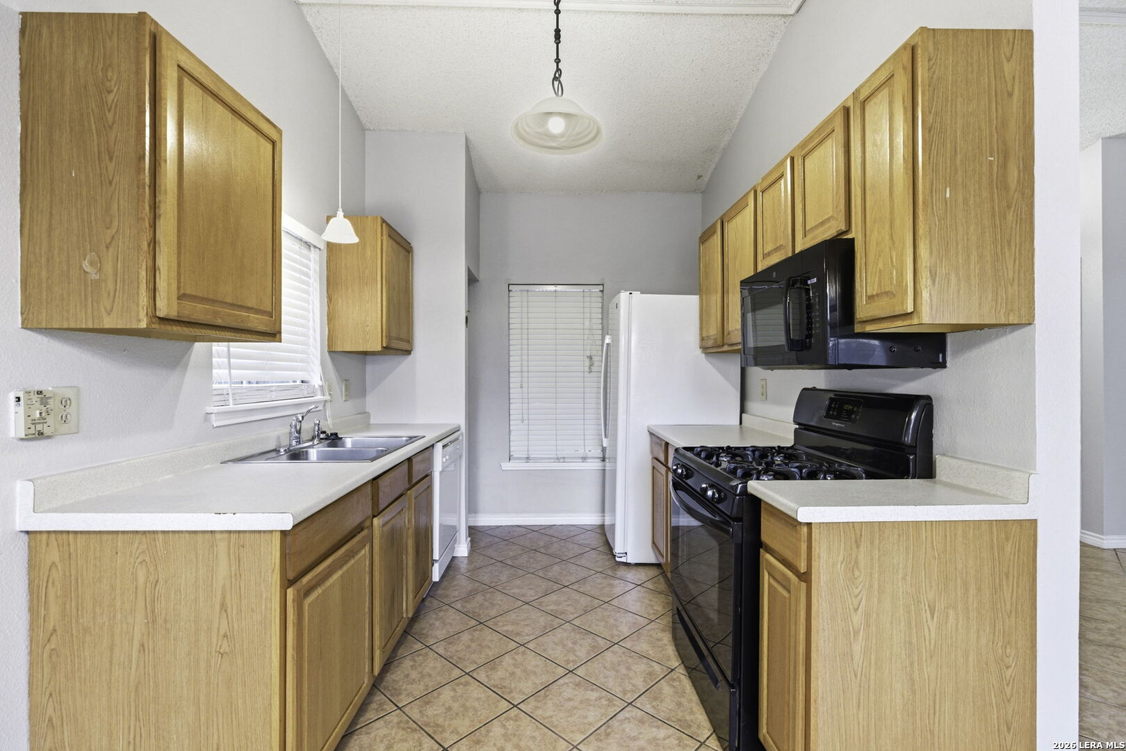 9439 Charter Point San Antonio, TX 78250 - Photo 7 of 14 a kitchen with stainless steel appliances granite countertop a sink stove and refrigerator